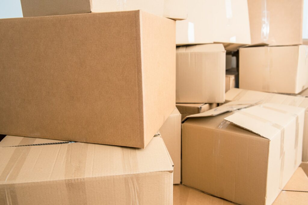 Family loses their home and moves, fills the cardboard boxes for the move due to the crisis.