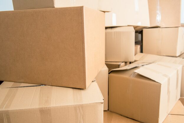 Family loses their home and moves, fills the cardboard boxes for the move due to the crisis.